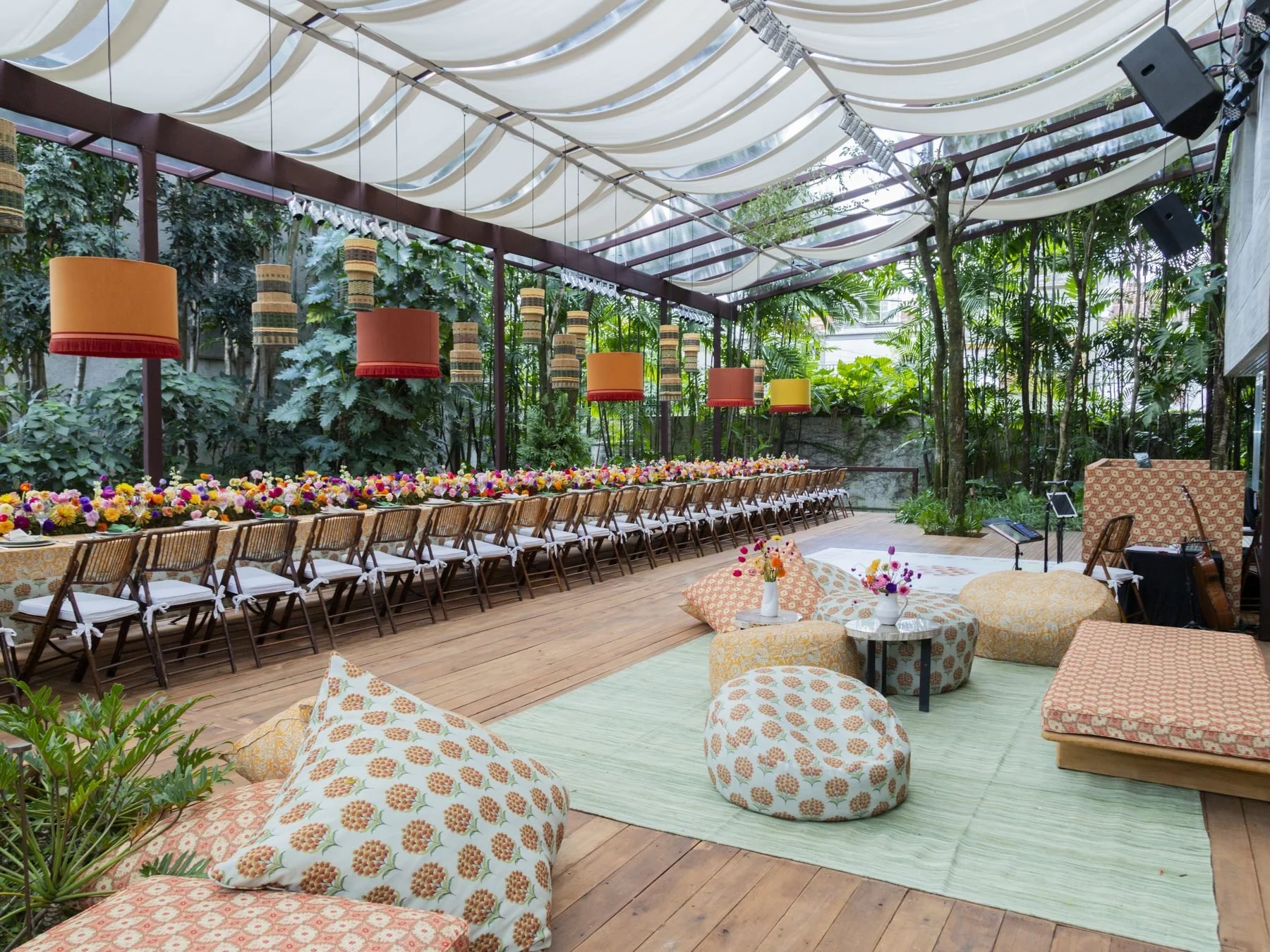 Lounge externo com almofadas e decoração floral