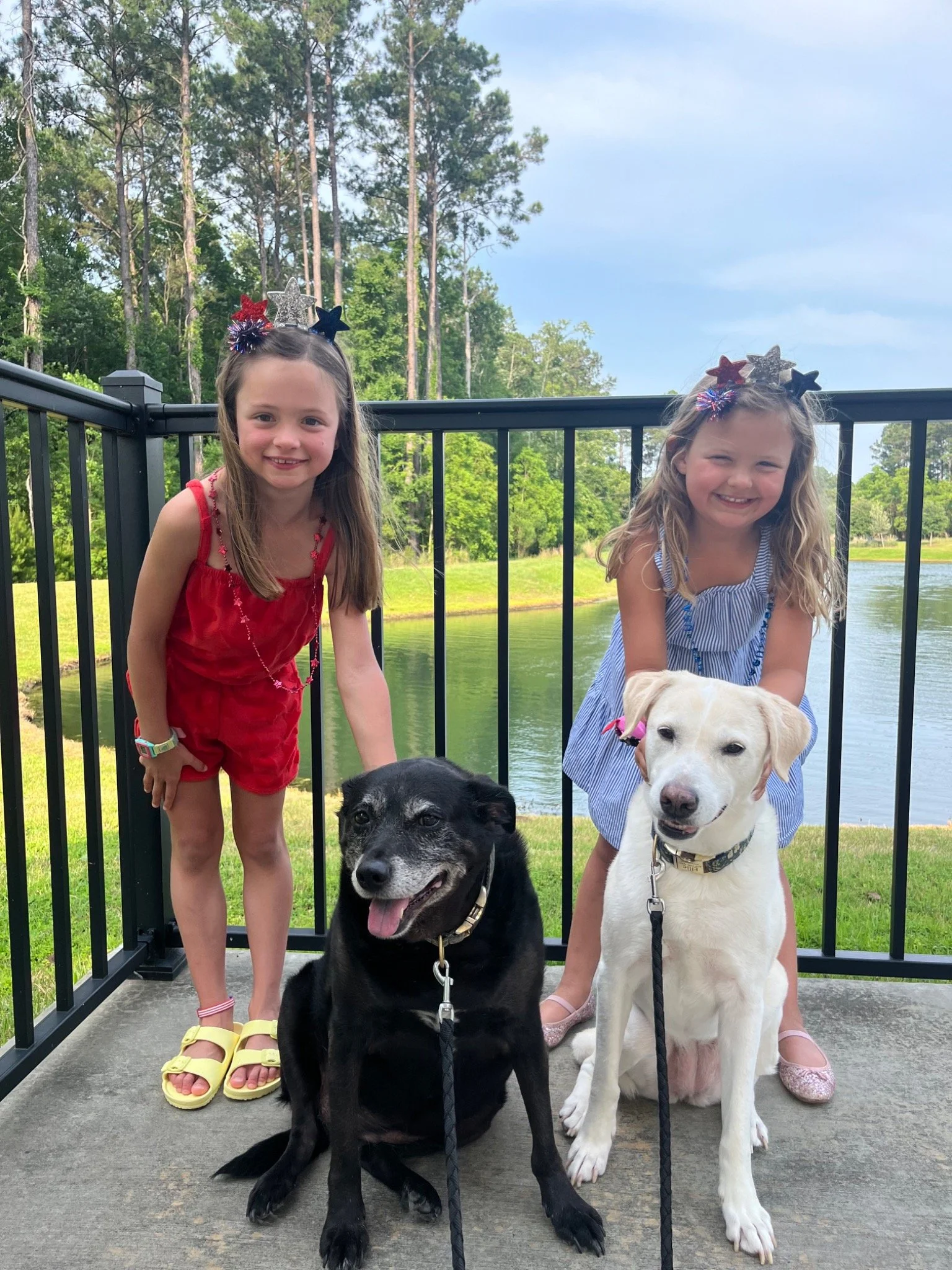 Jacob’s two daughters with the family’s two dogs