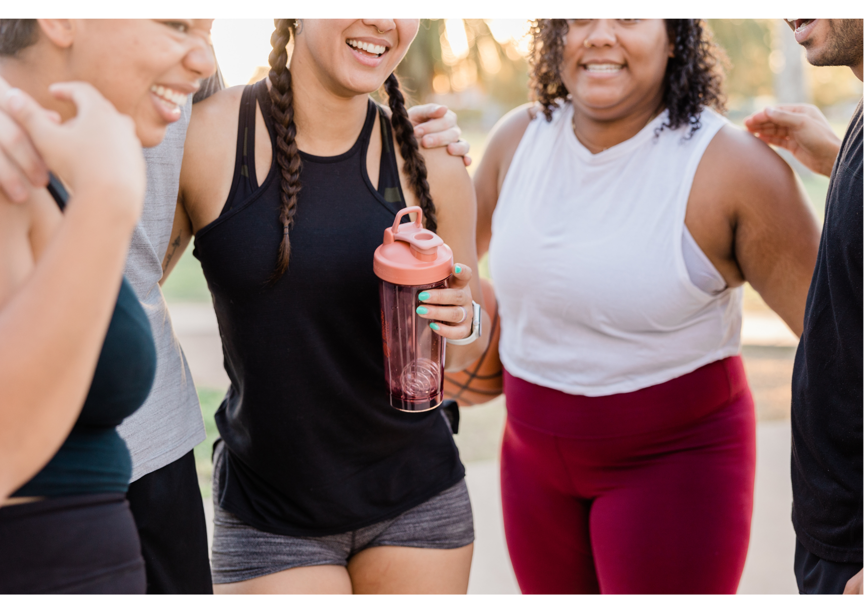 Women laughing together after an outdoor workout