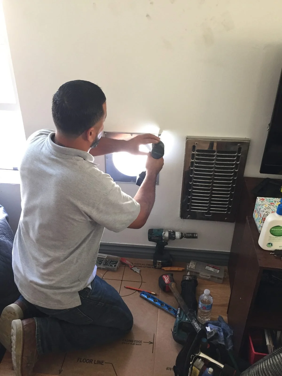 Ser Plumbing plumber inspecting under a bathroom vanity