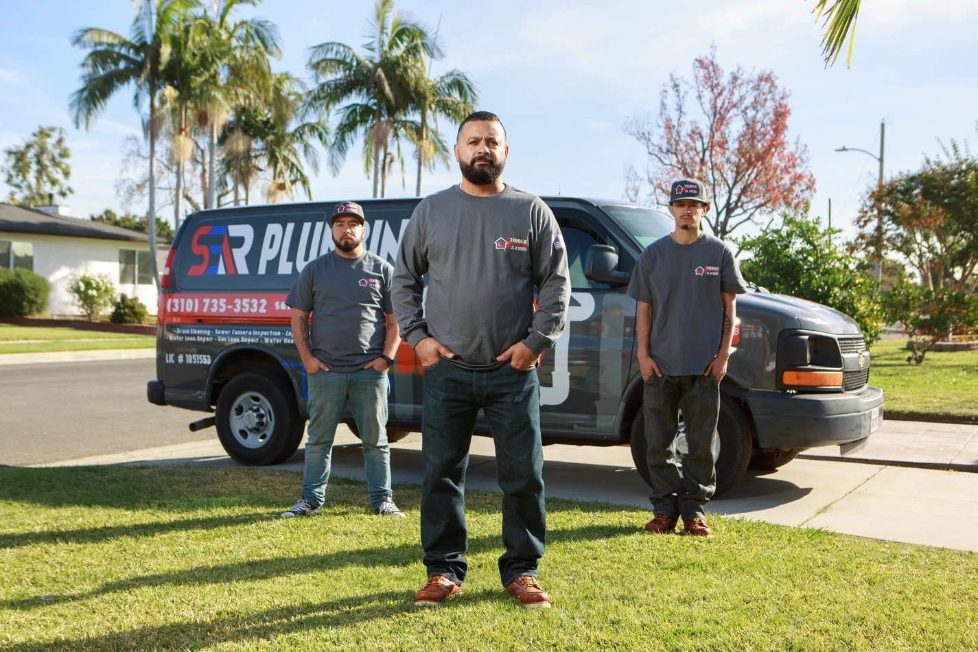 Ser Plumbing service van parked on a residential street in Paramount, CA