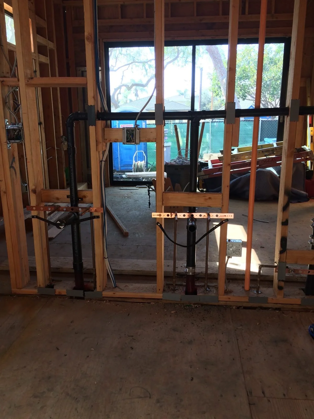 Ser Plumbing running new supply and waste lines under a sink