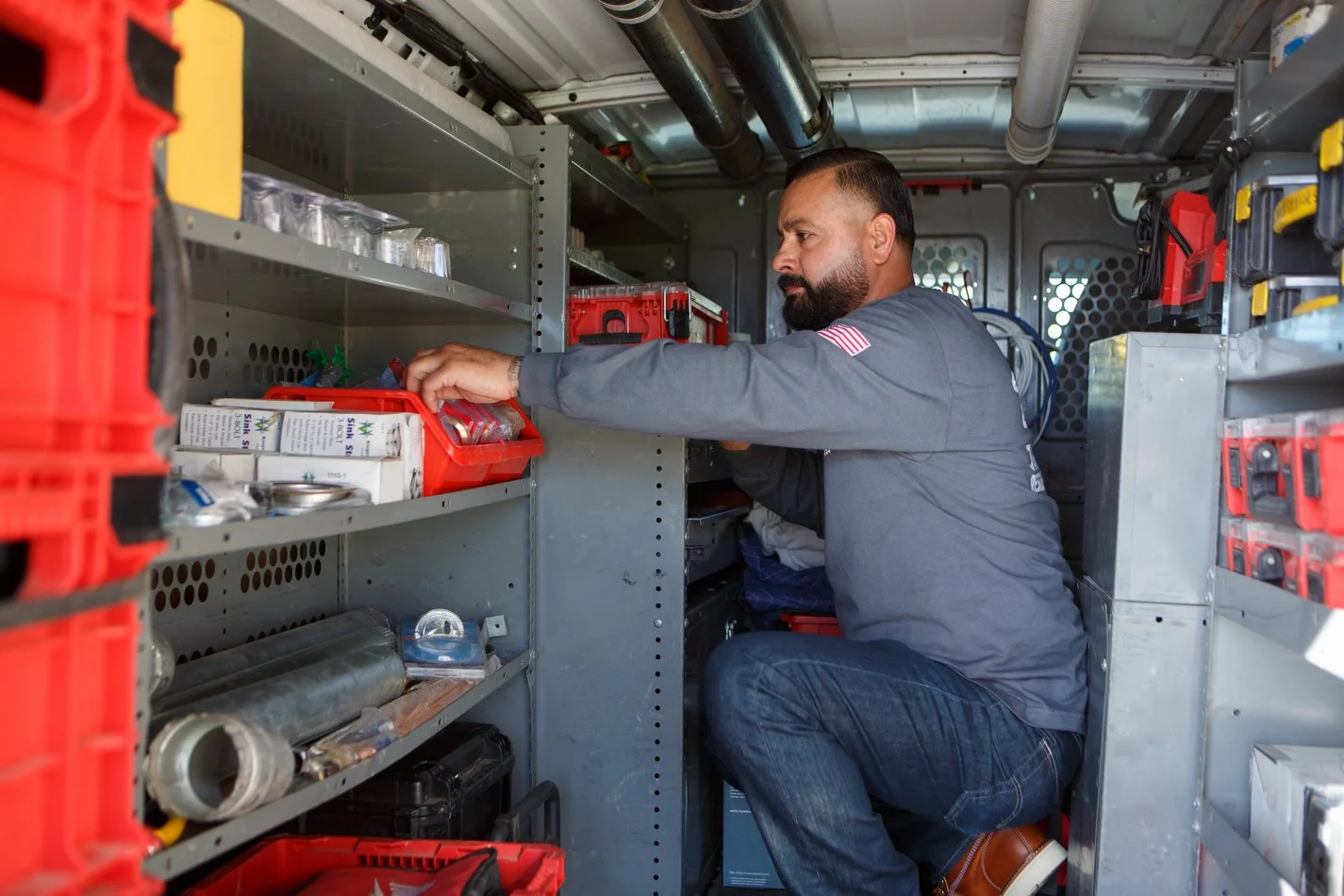 Ser Plumbing technician reviewing a written estimate with a homeowner