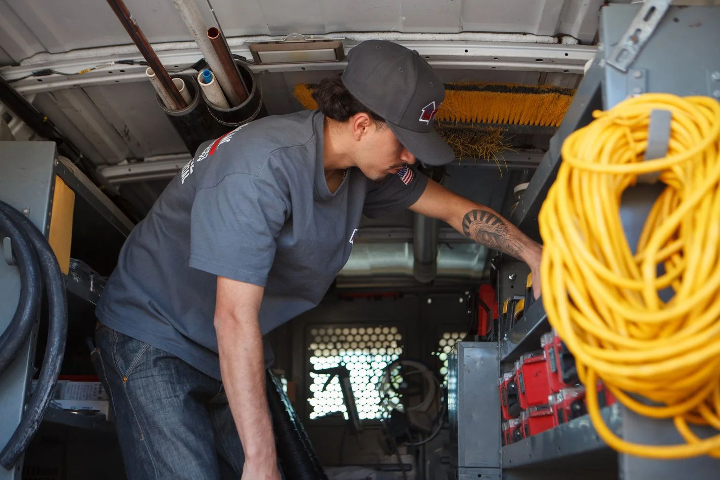 Ser Plumbing technician working at the van’s tool bay