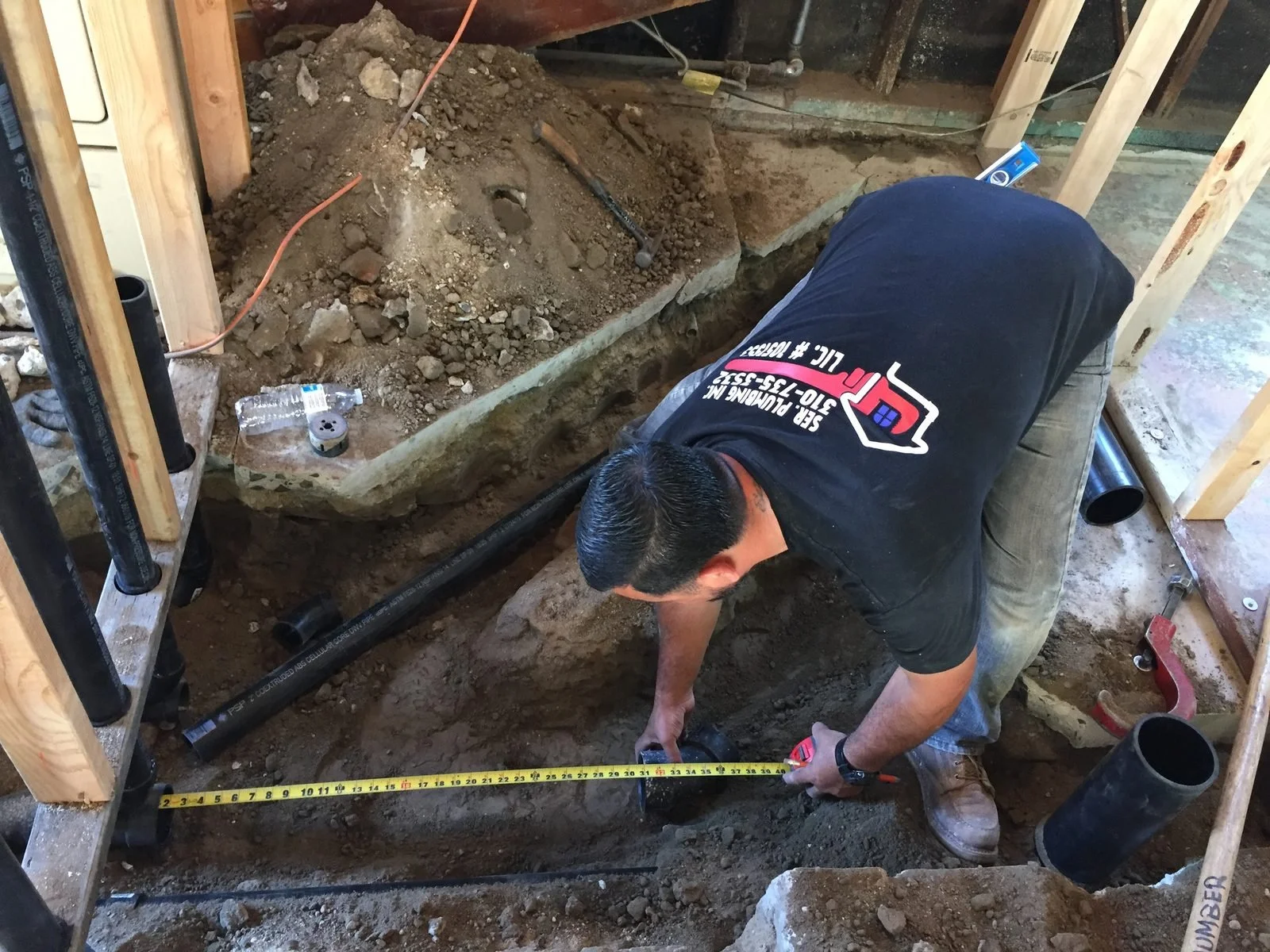 Ser Plumbing plumber connecting fixtures during a build-out