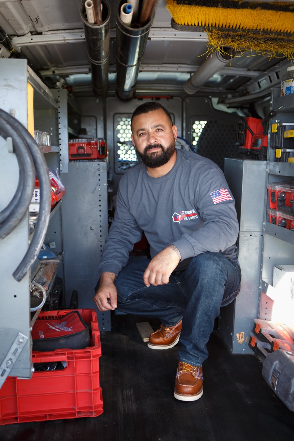 Ser Plumbing technician seated in the open service van