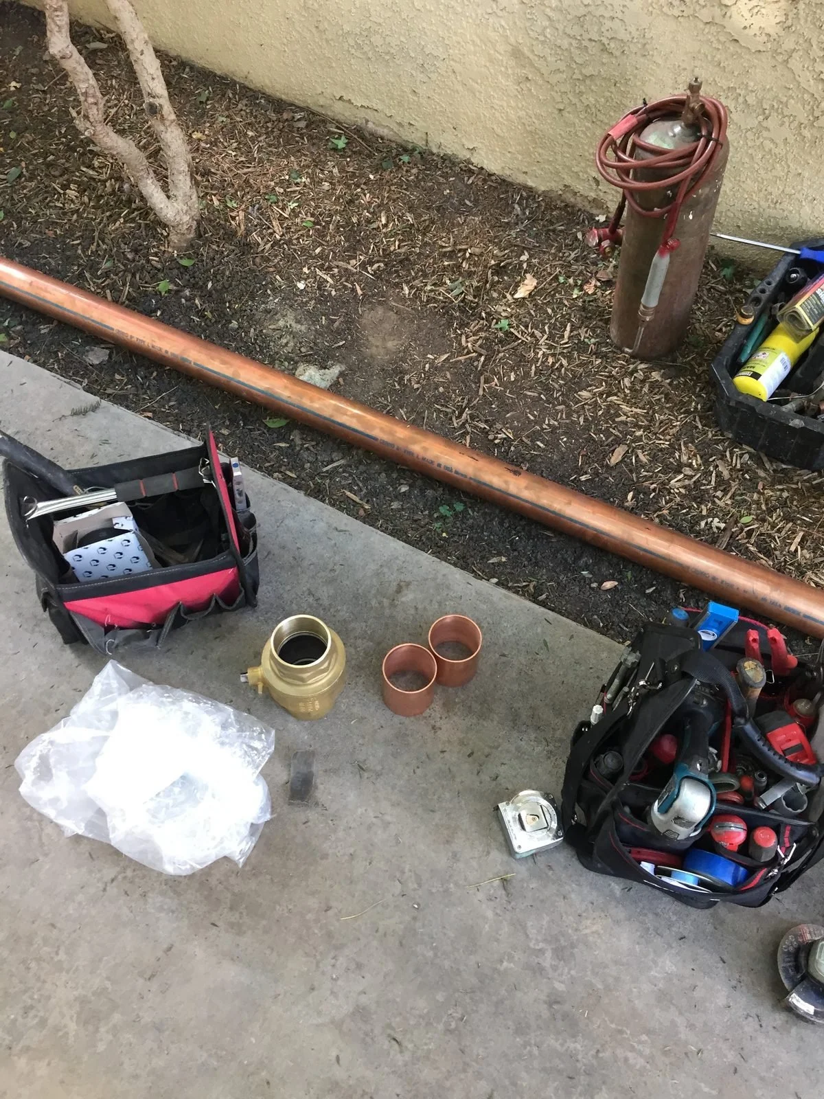 New copper repipe line staged along the side of a house — Ser Plumbing, Southeast LA County