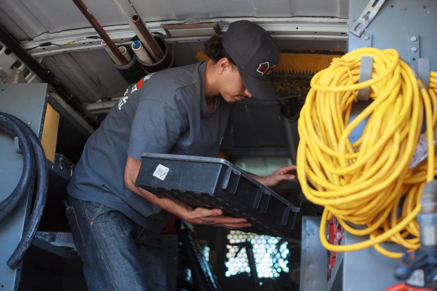 Ser Plumbing technician loading equipment into the service van