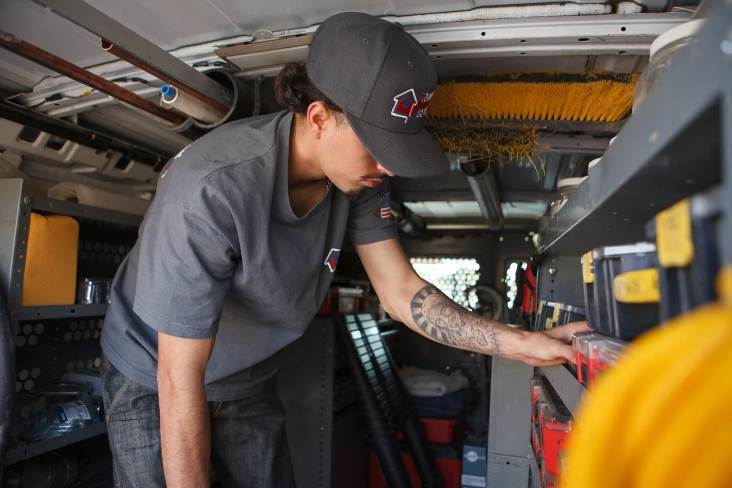 Ser Plumbing crew standing beside the service van on a residential street