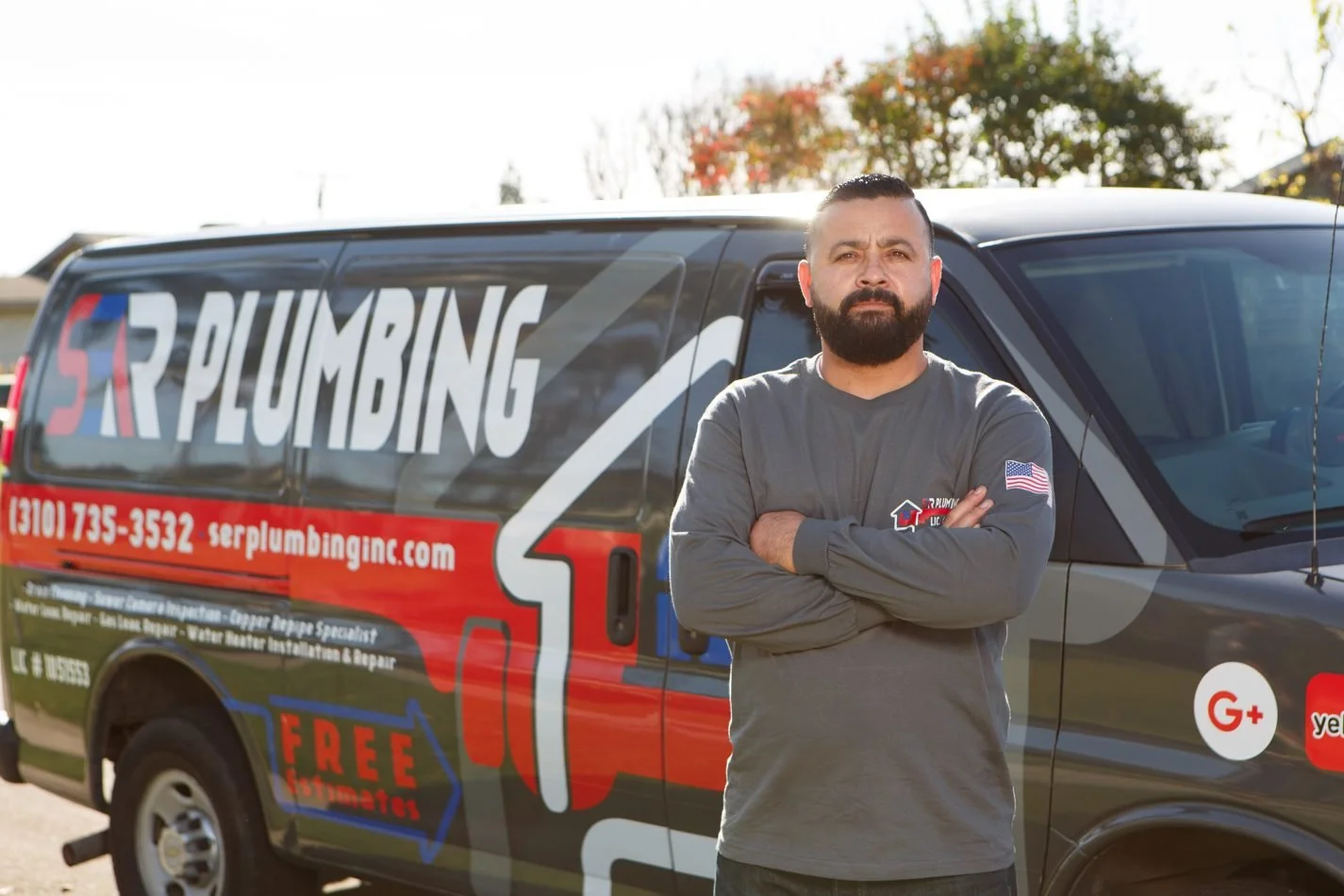 Jose Luis Serrano, owner of Ser Plumbing, beside the company van in Paramount, CA