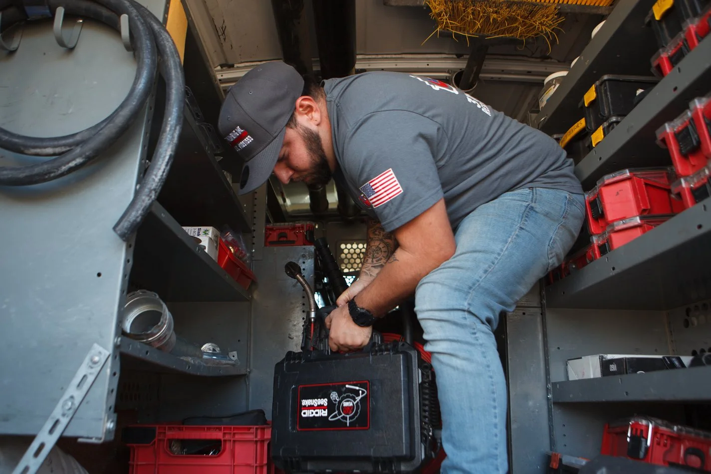 Ser Plumbing technician setting up equipment in the van bay