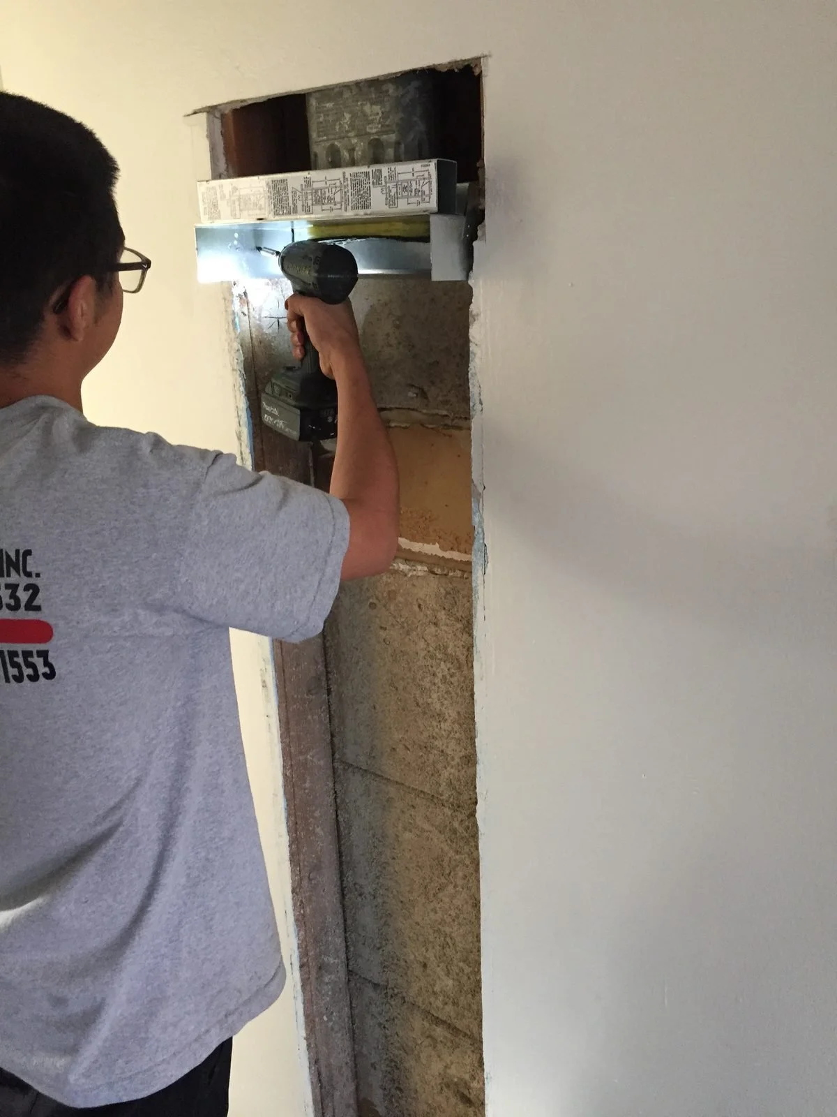 Ser Plumbing technician in a branded shirt on a Paramount service call