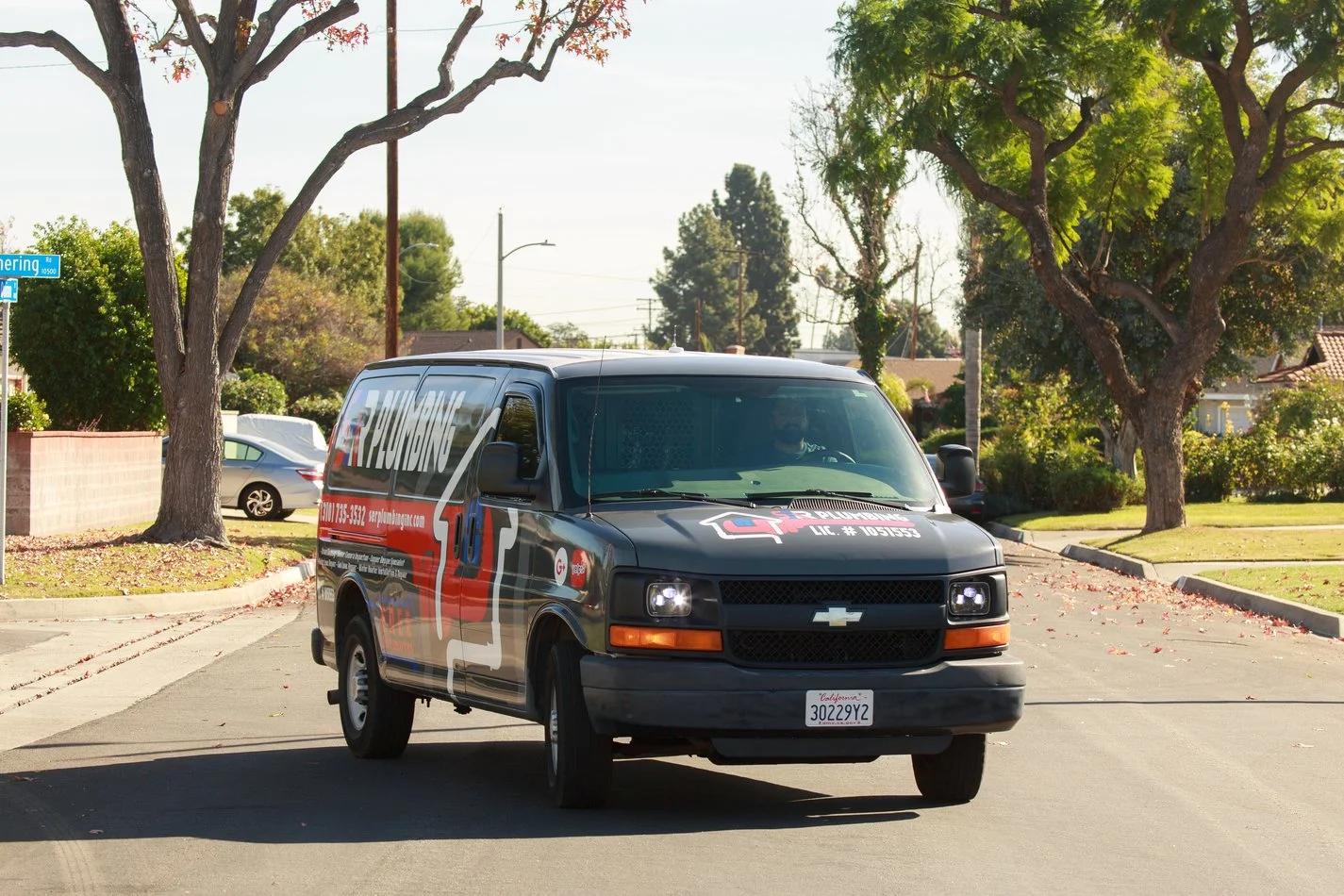 Ser Plumbing service van parked on a residential street