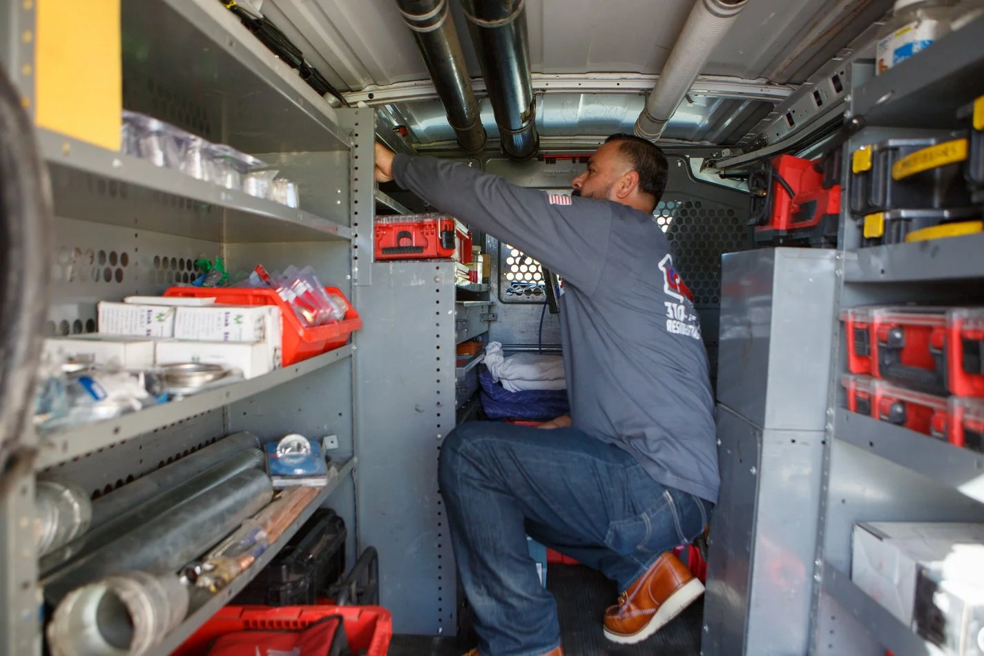 Ser Plumbing technician working at the van’s tool bay