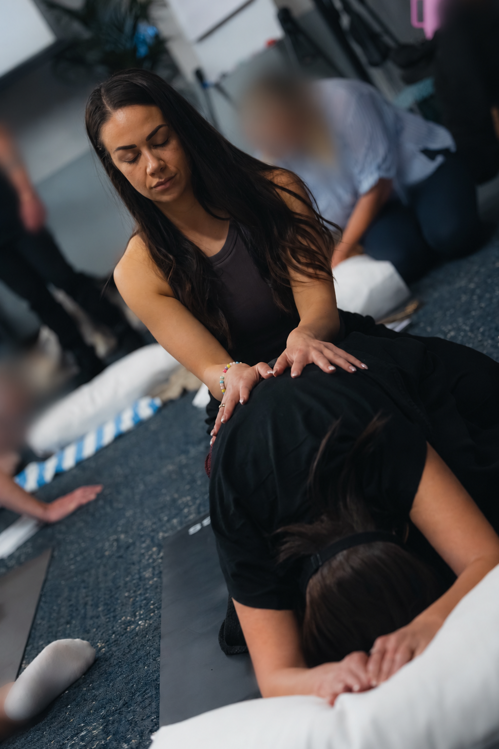 Cass supporting a woman through a hands-on practice