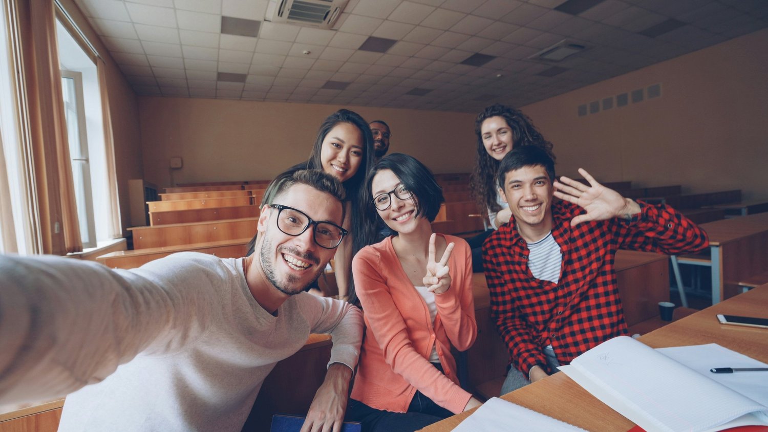 A group of students taking a selfie together in a classroom