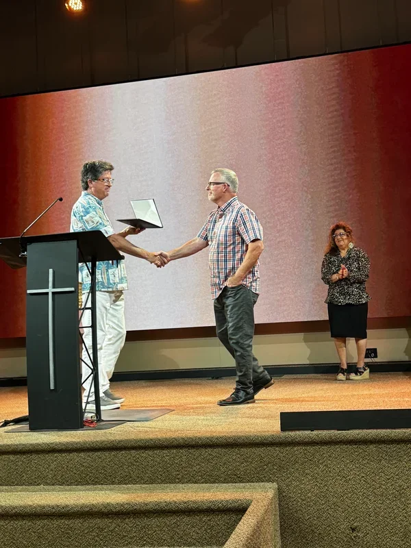 Lloyd Pulley shakes hands while receiving a certificate at Calvary Chapel Old Bridge.