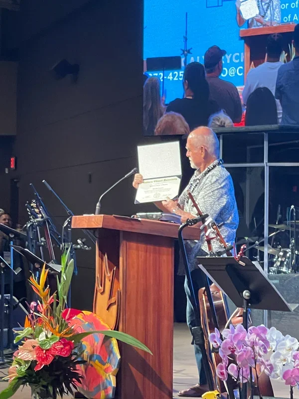 Bill Stonebreaker displays an honorary doctorate certificate at Calvary Chapel Honolulu.