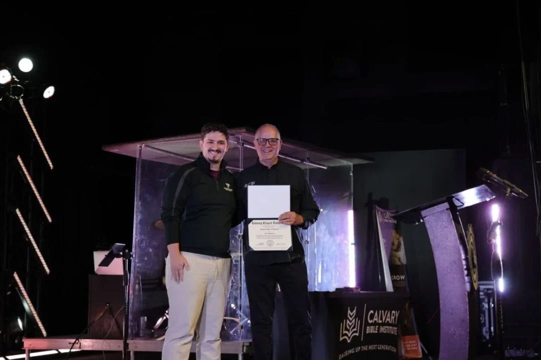 Jerel Hagerman receives an honorary doctorate alongside a Calvary Bible Institute representative.