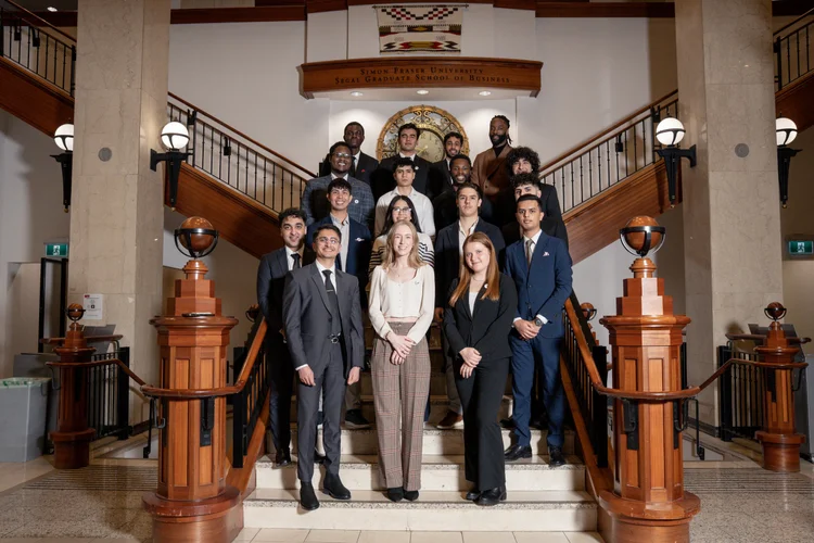 SFU Economics Student Society members posing on a staircase.