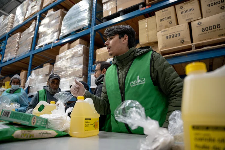 A volunteer sorting supplies in the Muslim Food Bank warehouse in Surrey.