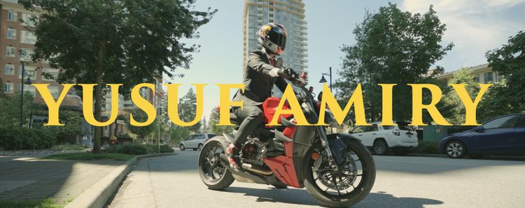 A rider on a motorcycle under the Yusuf Amiri name.