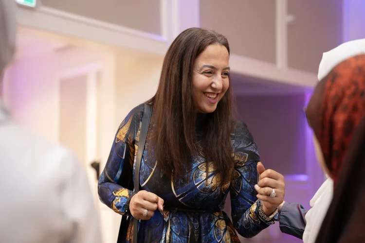 A woman smiling at a NISA Foundation event.