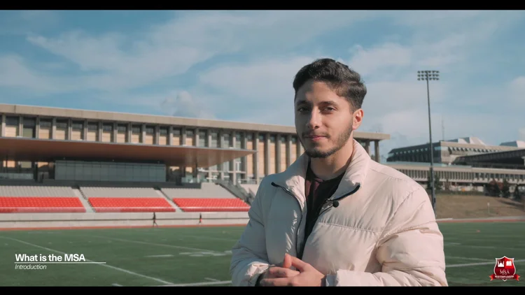 A student speaking to camera on the SFU campus.