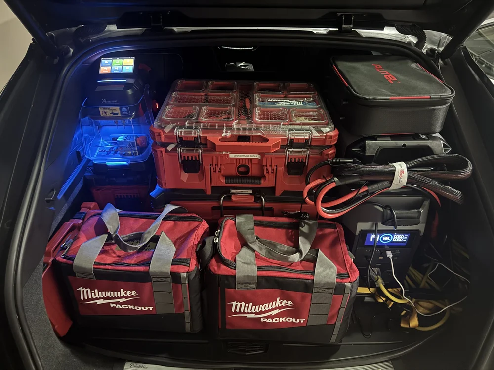 The Apex Vehicle Access mobile lab loaded out: key cutting machine, diagnostic tablet, tool cases and a portable power station in the back of the service vehicle.