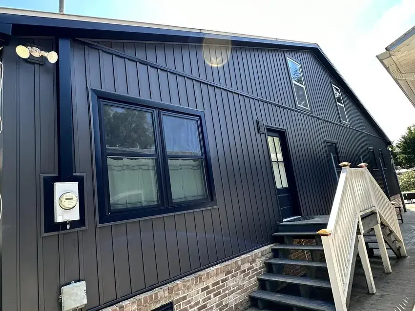Dark vertical siding with black windows