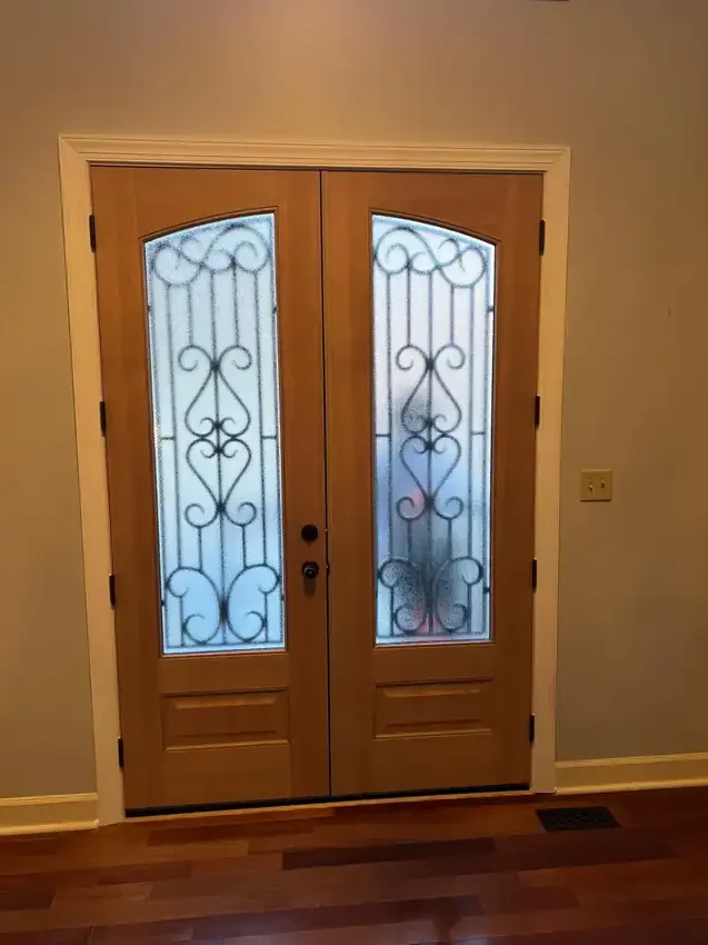 Natural wood double entry doors with decorative glass