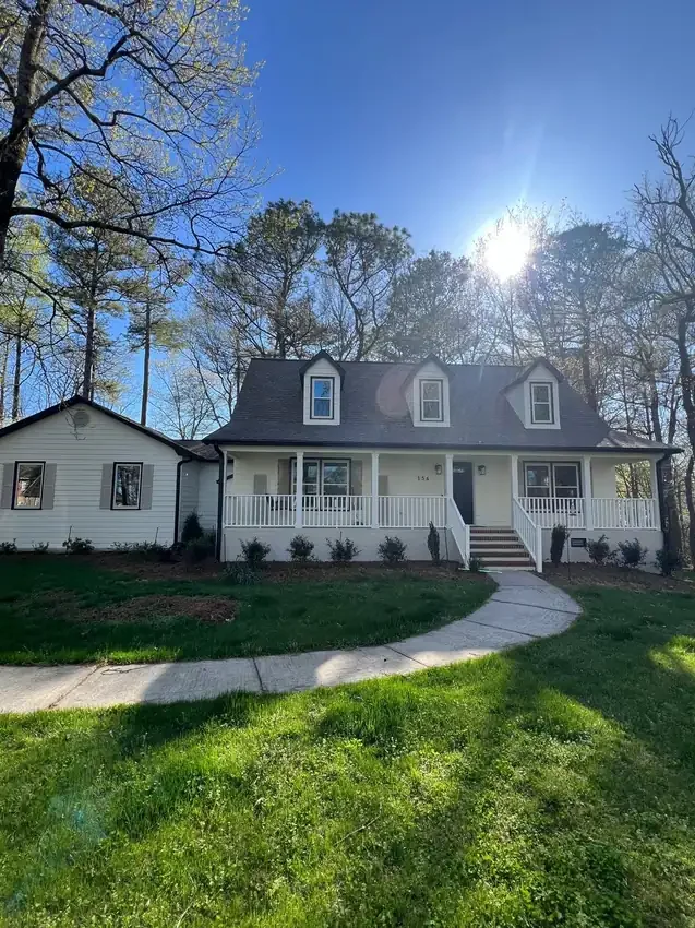 White home with dormers and coordinated replacement windows