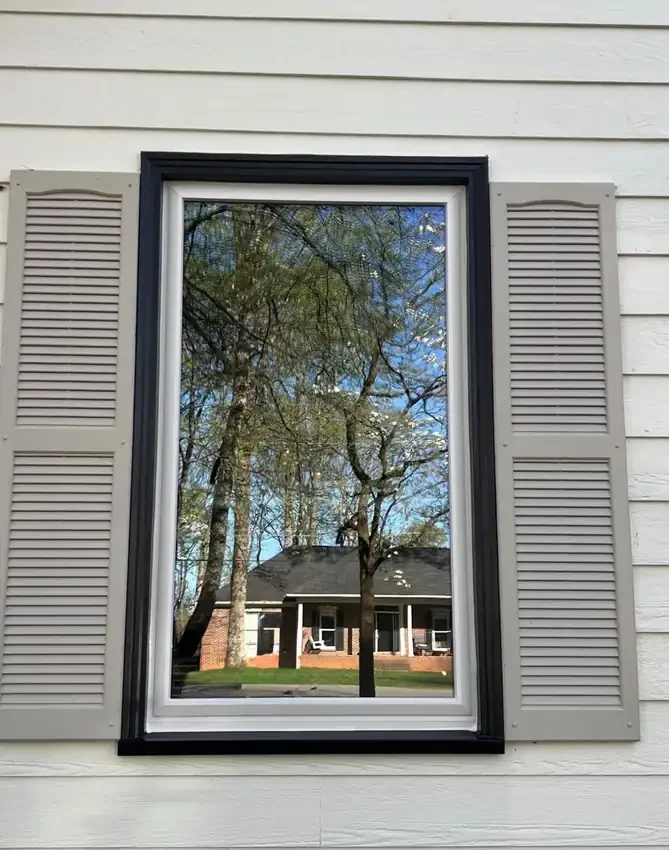 Finished white window with contrasting black exterior trim