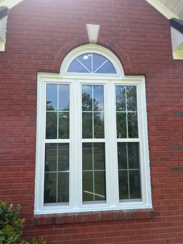 Three-window composition with a half-round window above