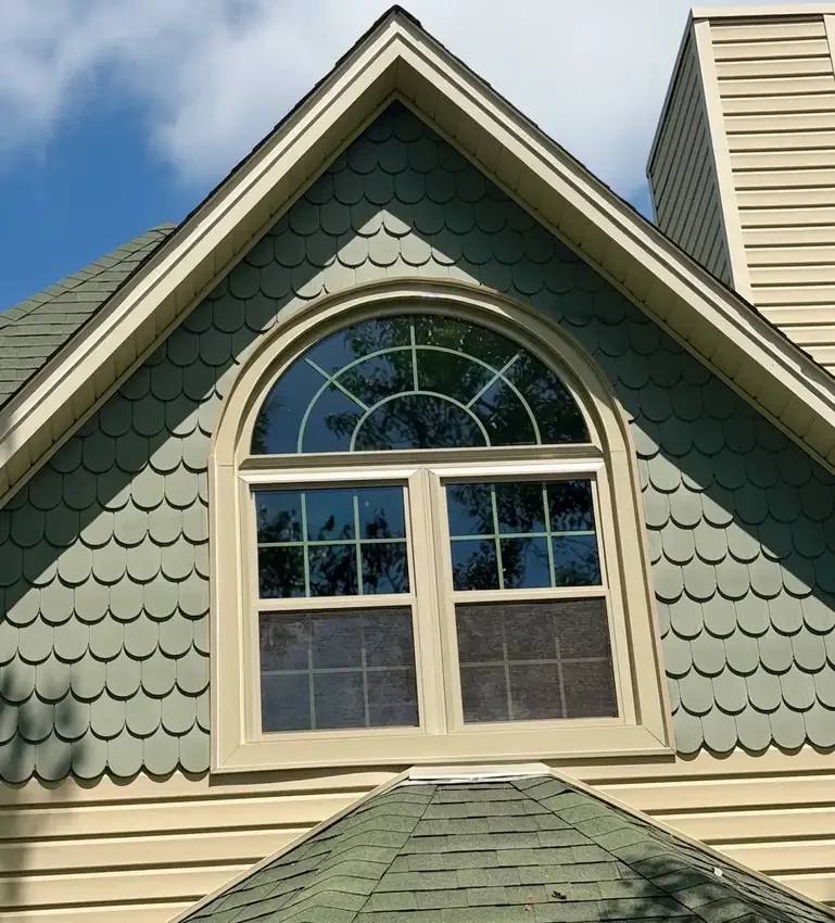 Double-hung windows with a half-round above in a gable