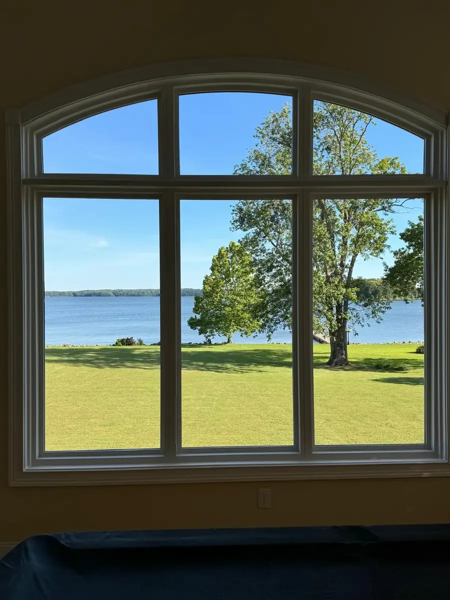 Large interior window composition overlooking a lake