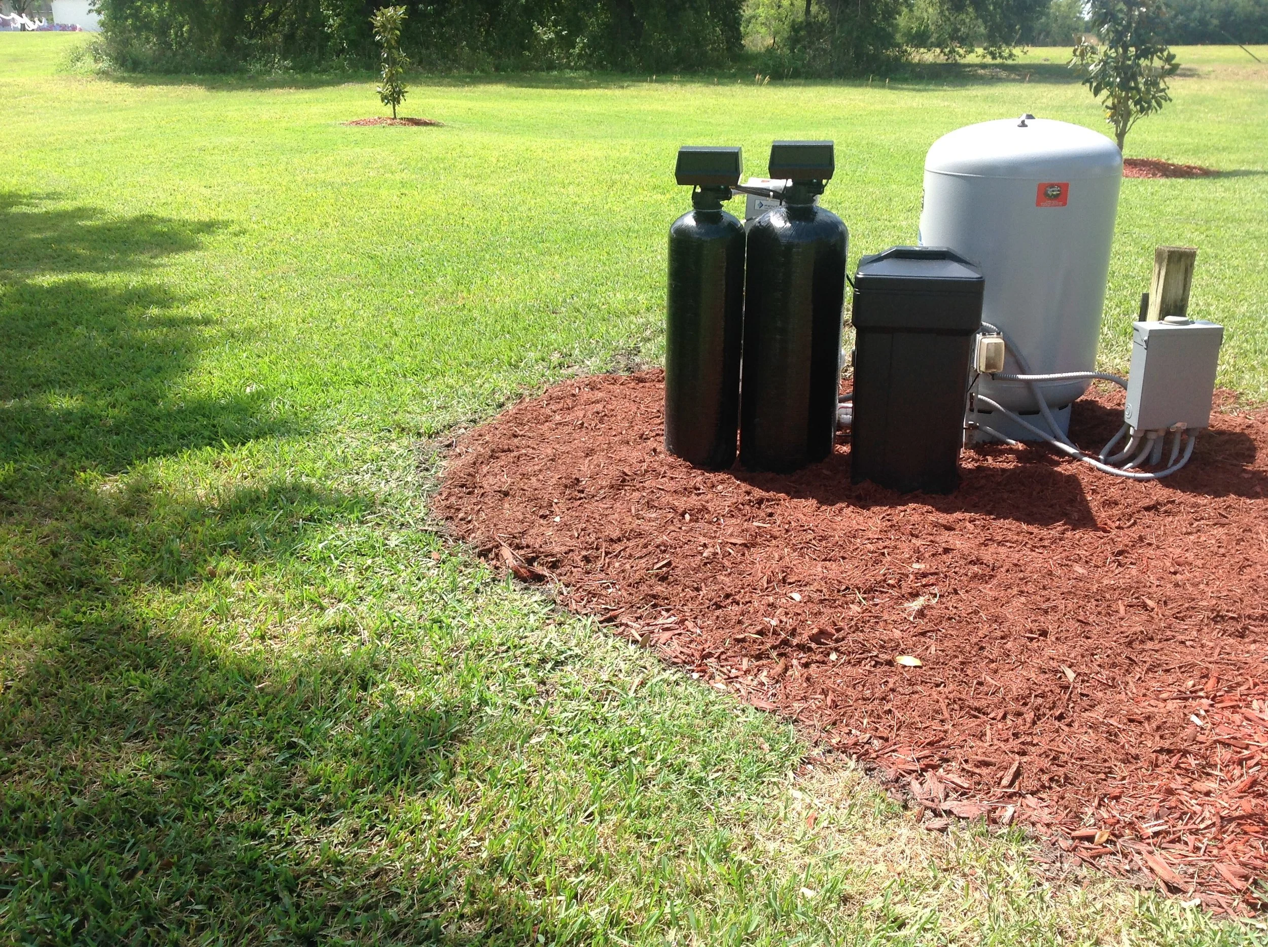 Treatment tanks set on a mulched bed - Pump Repair Services, Orlando FL