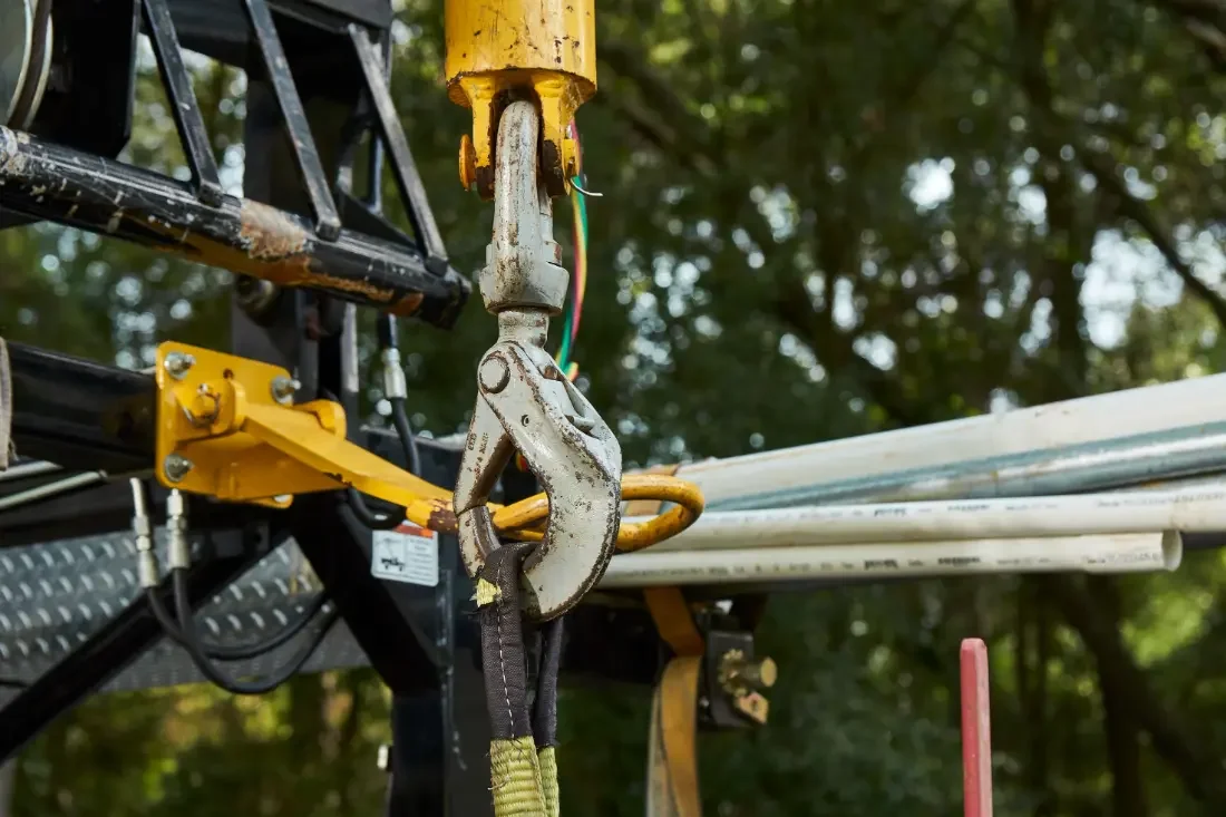 Hoist hook rigged over a Central Florida wellhead