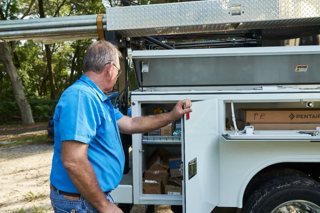 Checking job notes at the open service truck in Eustis, Florida