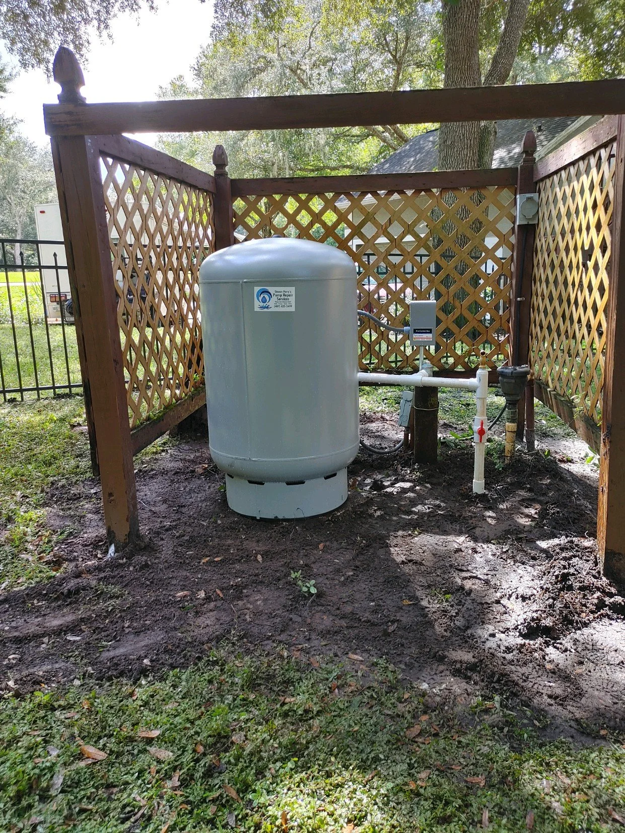 Pressure tank under a timber well cover - Pump Repair Services, Orlando FL