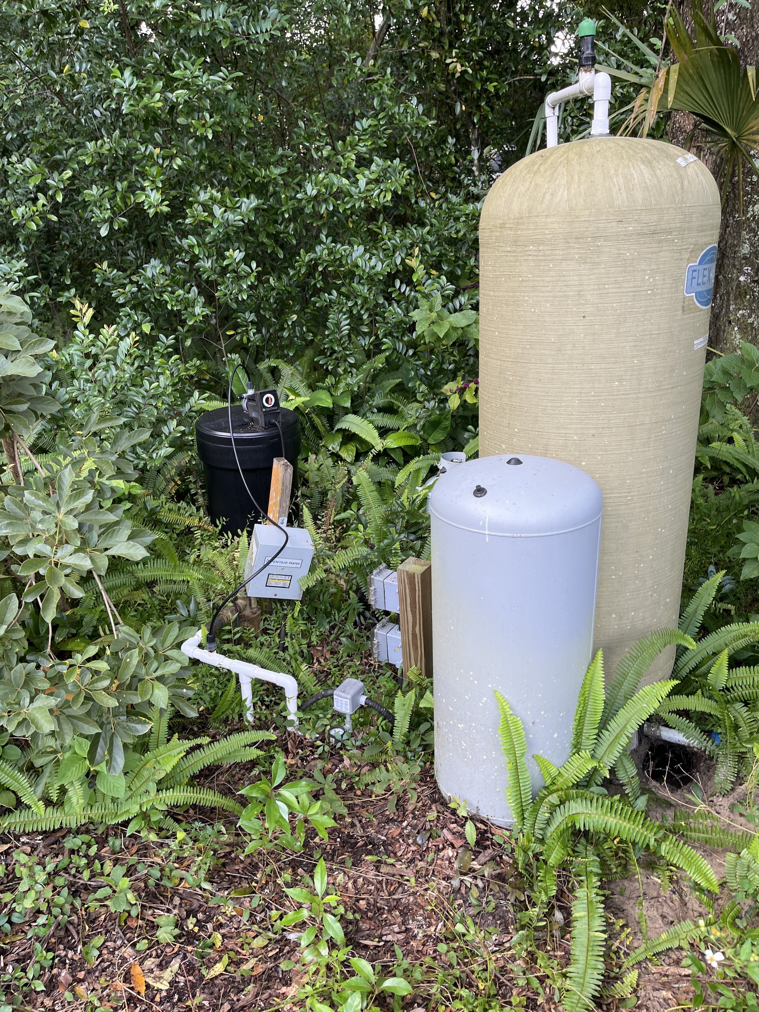 Pump and tank installed in a garden bed - Pump Repair Services, Orlando FL