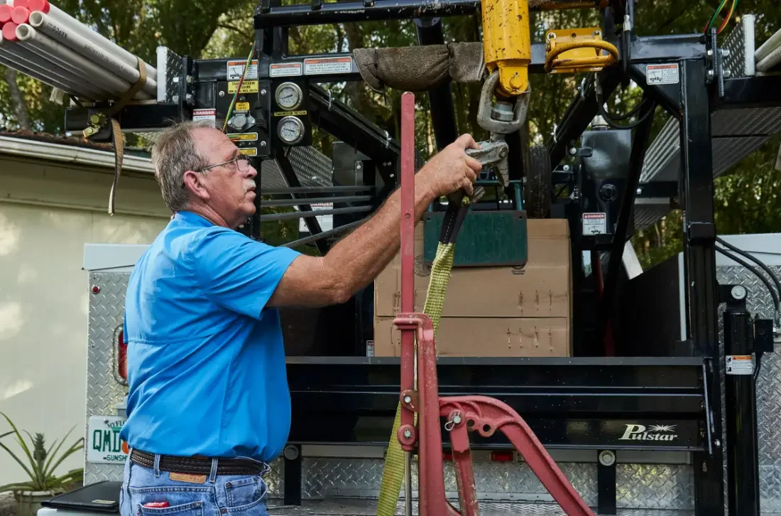 Rigging a submersible pump on the hoist in Mount Dora, Florida