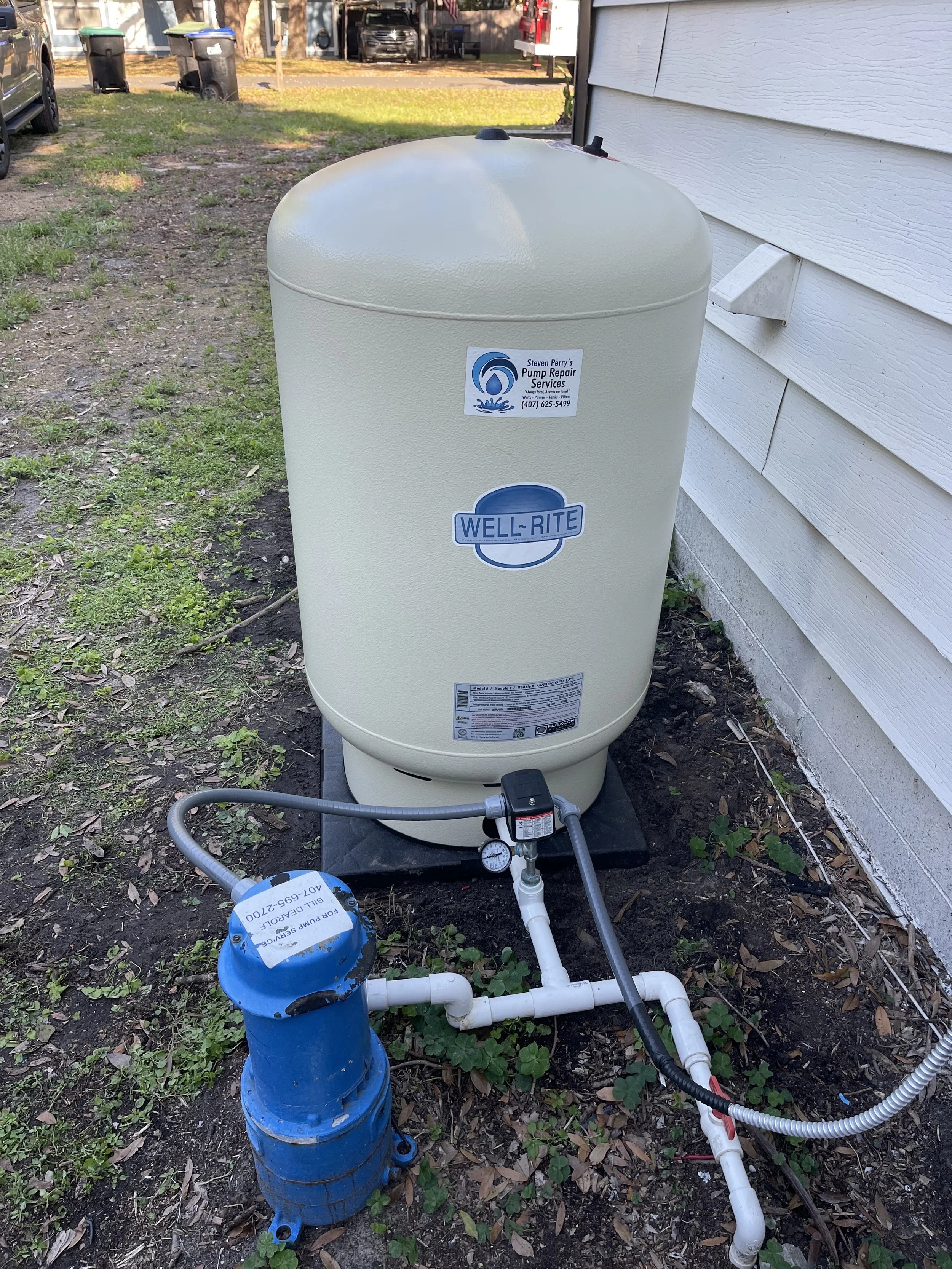 Pressure tank and booster valve at a wall - Pump Repair Services, Orlando FL