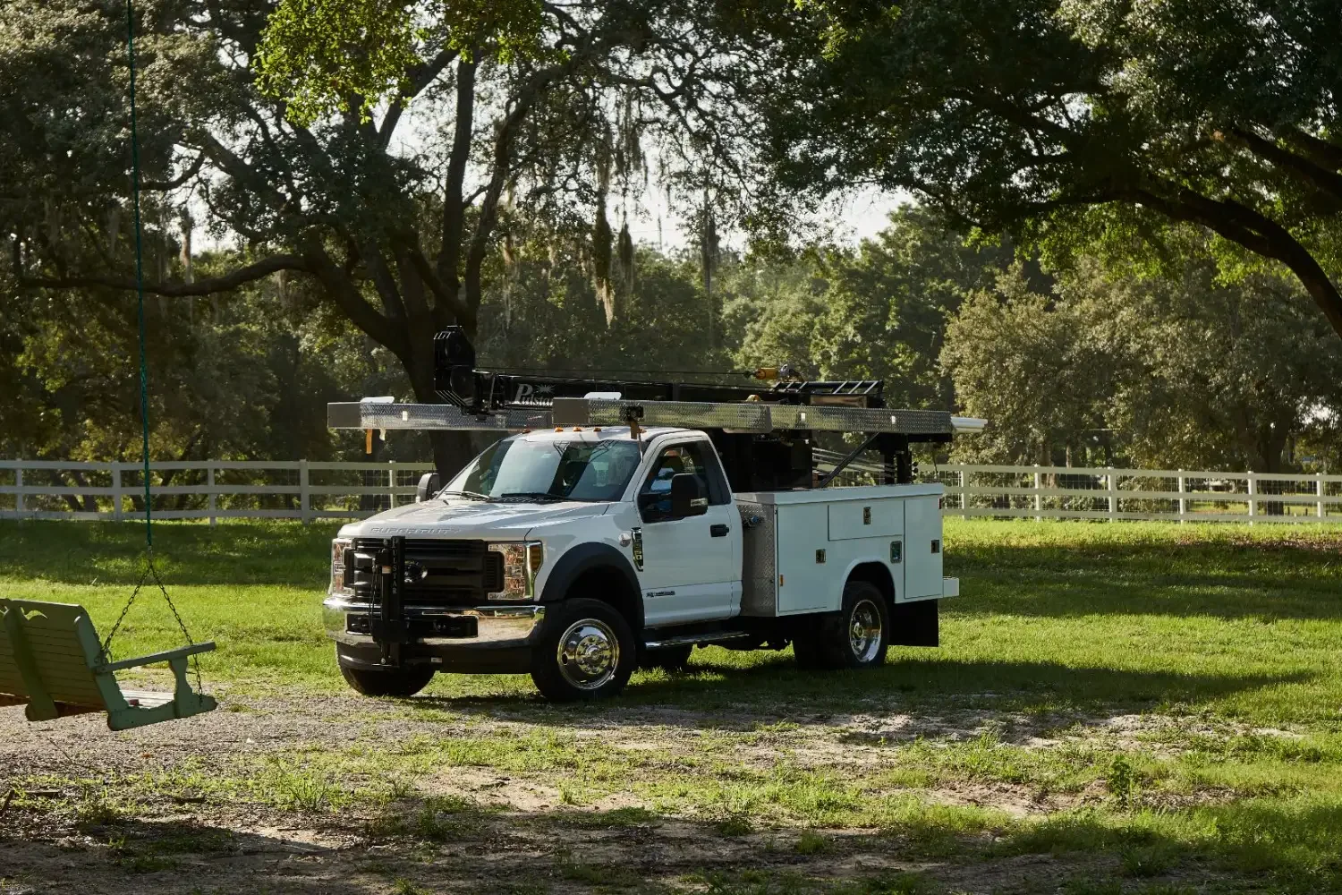 Pump Repair Services boom truck parked under Central Florida oaks