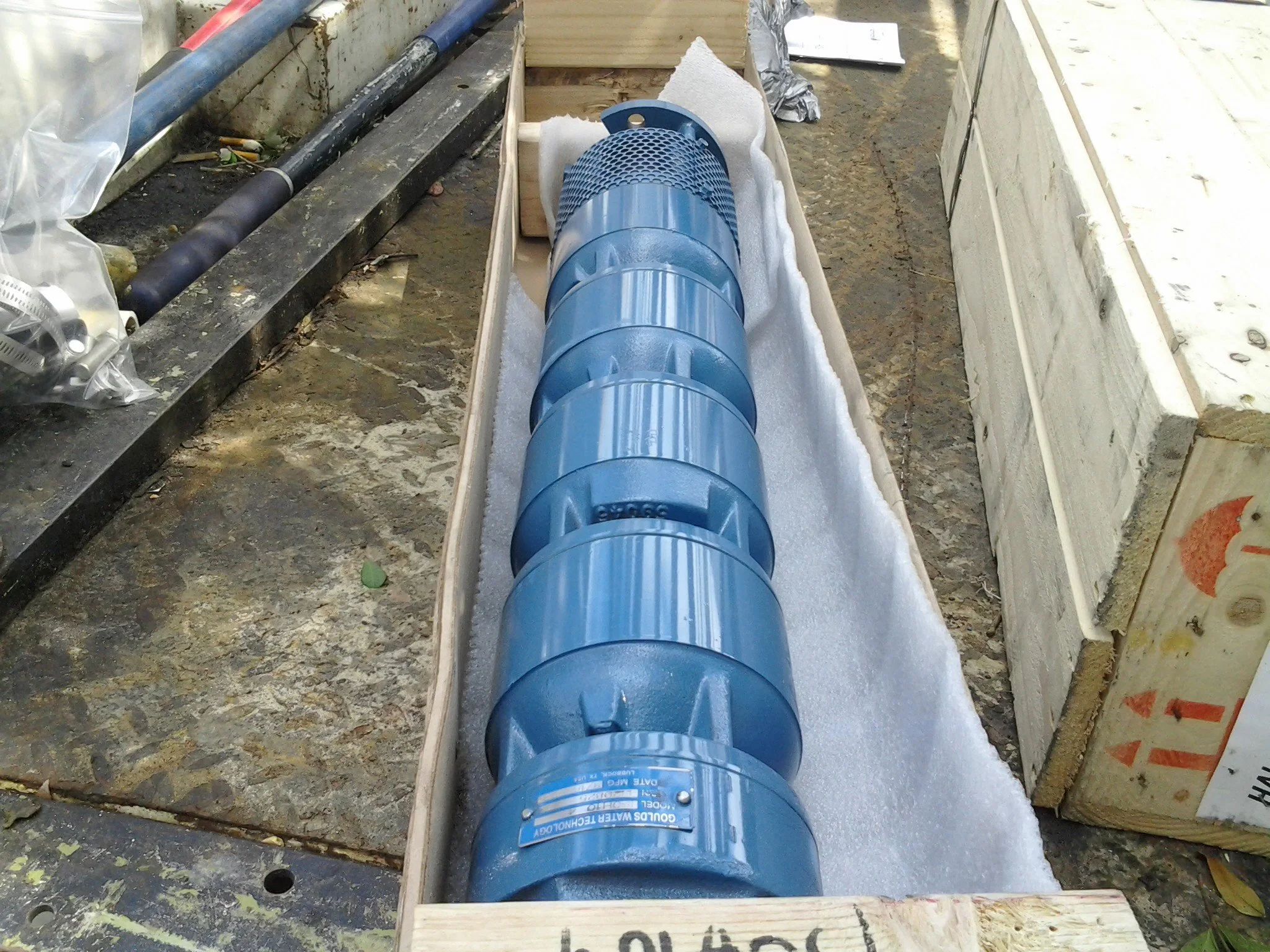 Submersible pump and drop pipe laid out in a trench - Pump Repair Services, Orlando FL