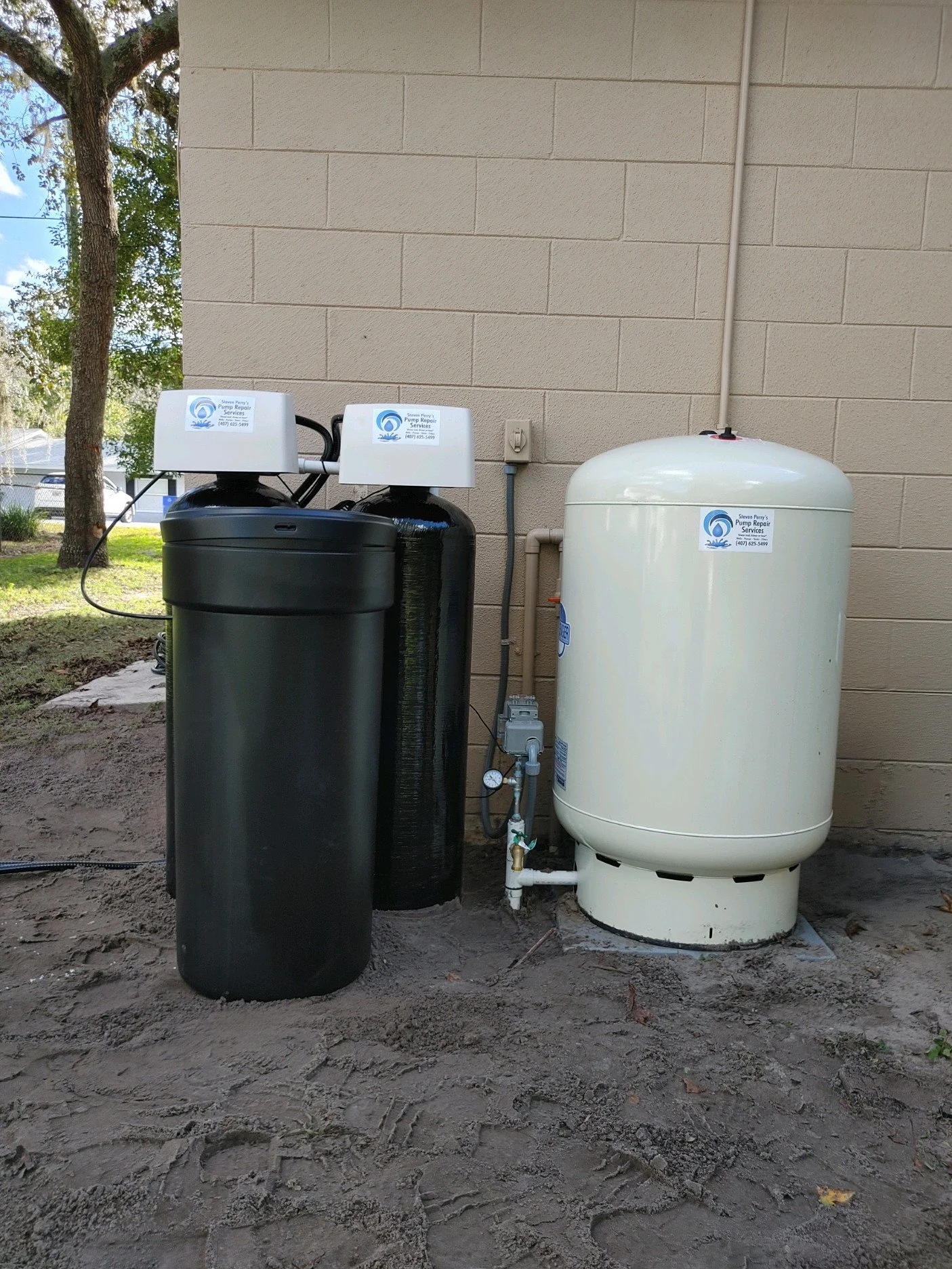 Softener and pressure tank beside the wall - Pump Repair Services, Orlando FL