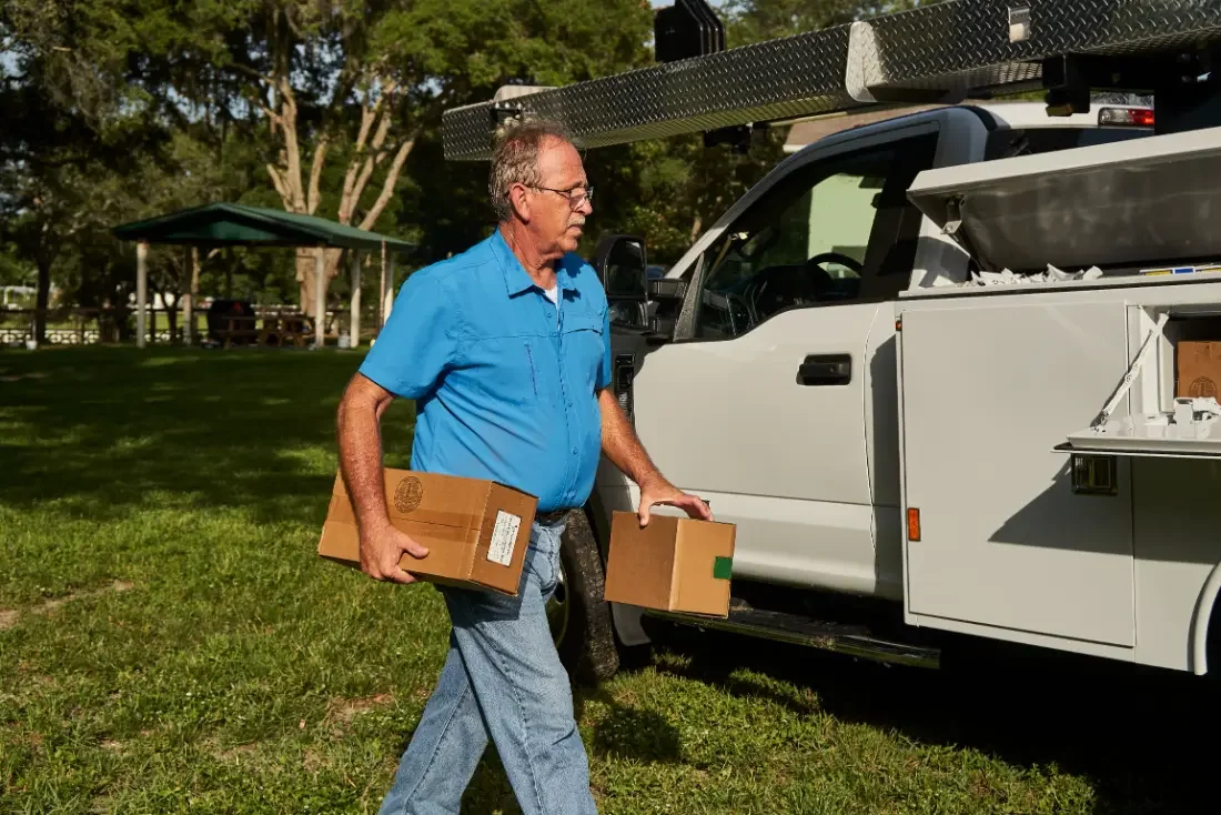 Steven Perry carrying parts from the Pump Repair Services truck