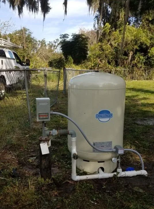 Booster pump and tank beside the house - Pump Repair Services, Orlando FL