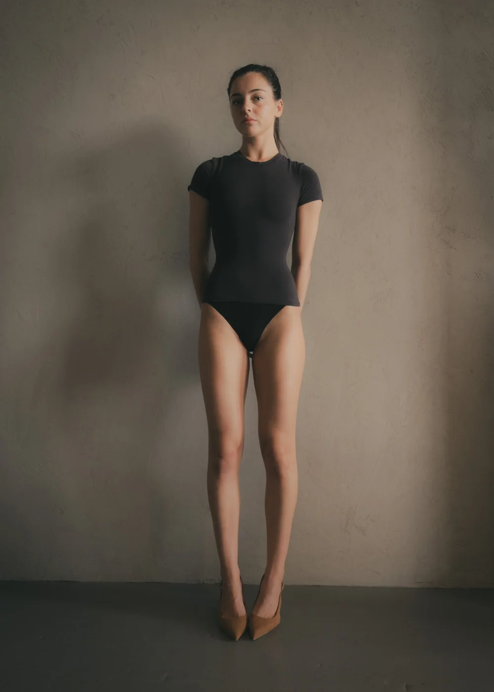 LILY × MINT — Front-facing full-length fashion portrait in a fitted black T-shirt and tan heels, photographed by CAMR Visuals.