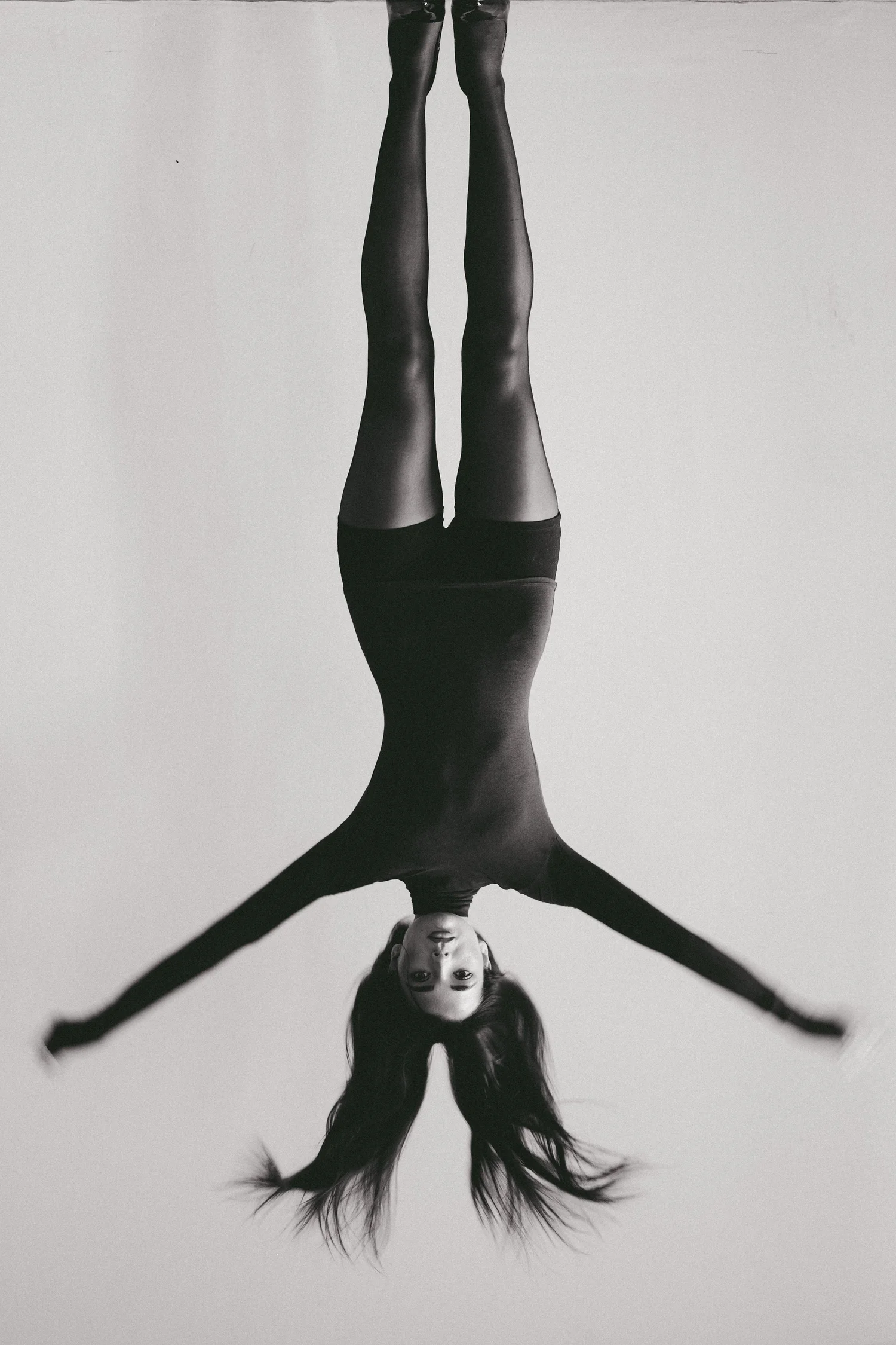 Inverted black and white editorial fashion portrait of a model in a bodysuit, photographed by CAMR Visuals in Manchester